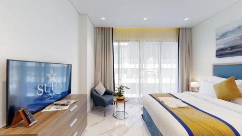 a bedroom with a large bed and a large window at SUHA Mina Rashid Hotel Apartments in Dubai