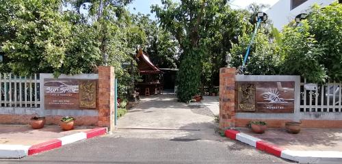 a gate to a building with a white fence at Sun smile(cafe & homestay) in Ubon Ratchathani
