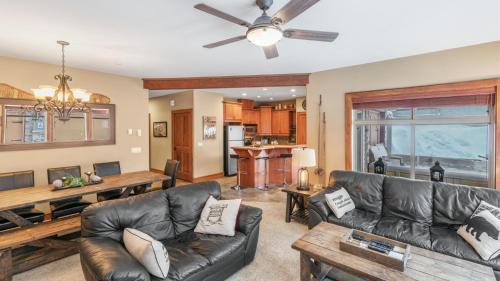 a living room with a couch and a table at I Spy - Cozy Pet Friendly, Ski In Ski Out Condo with Private Hot Tub in Big White