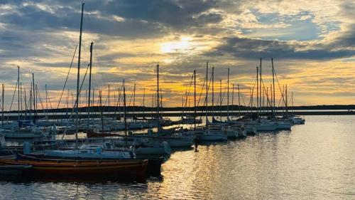 a group of boats docked in the water at sunset at Le Gîte de Saint Phal in Saint-Phal