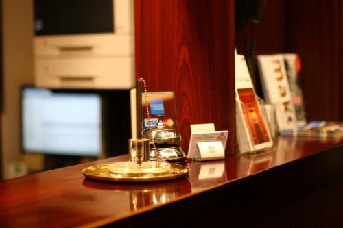 a bar with a gold plate on a wooden counter at Hotel Imperial in Cologne