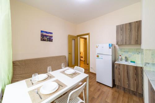 a small kitchen with a table and a refrigerator at #Go2SPB - SOUTH View Apartment SOFIA in Saint Petersburg