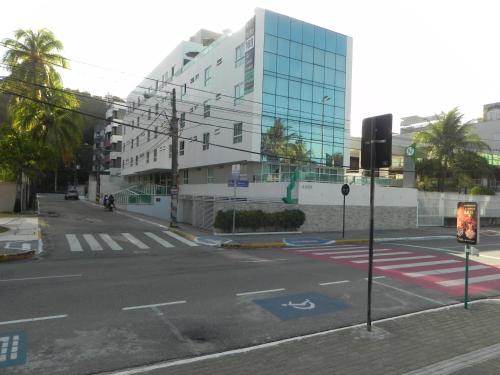 an empty street in front of a large building at Flat Easy Sunset in João Pessoa