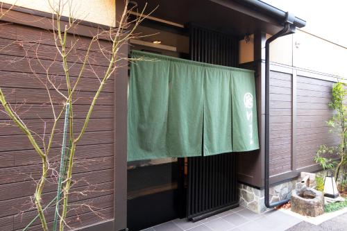 a green curtain on the side of a building at Oyado Yukizumi in Kusatsu