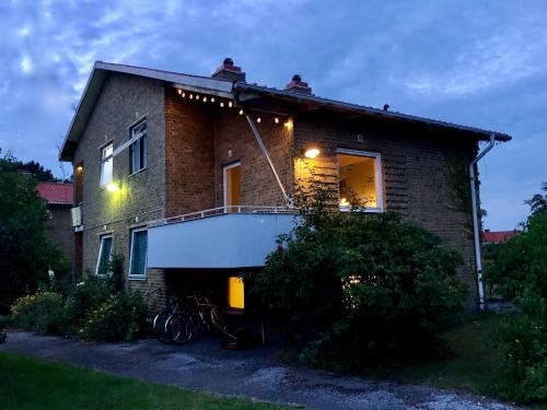 a house with a balcony on the side of it at Hemmet B&B in Simrishamn