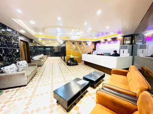 a lobby with couches and a bar in a building at Blue Diamond Resort & Hotel in Muzaffarpur