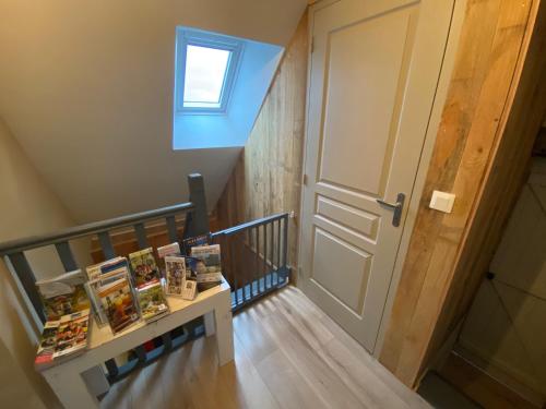 a staircase with a door and a shelf with books at gite du perche in Bueil