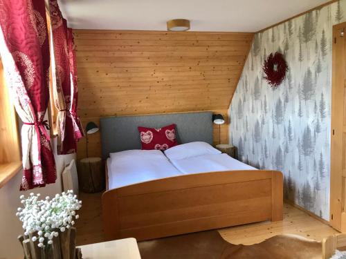 a bedroom with a bed in a wooden room at Liptovské Chaty in Liptovský Mikuláš