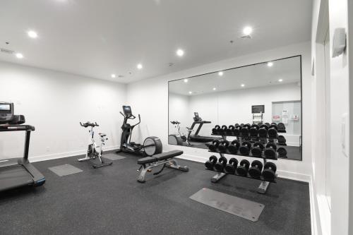 a gym with a mirror and some exercise equipment at Lake Placid Inn Boutique Hotel in Lake Placid