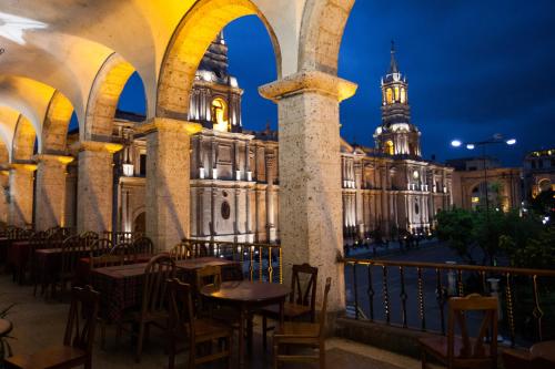 a view of a building with tables and chairs at La Plaza Arequipa Hotel Boutique in Arequipa