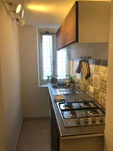 a kitchen with a stove and a counter top at Sofia guest house in Rome