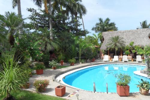 a beach with a pool, chairs, and a pool table at Casa Virgilios B&B in Nuevo Vallarta