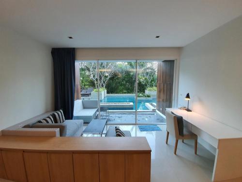 a living room with a couch and a table at Mida de Sea Residence Hua Hin in Cha Am