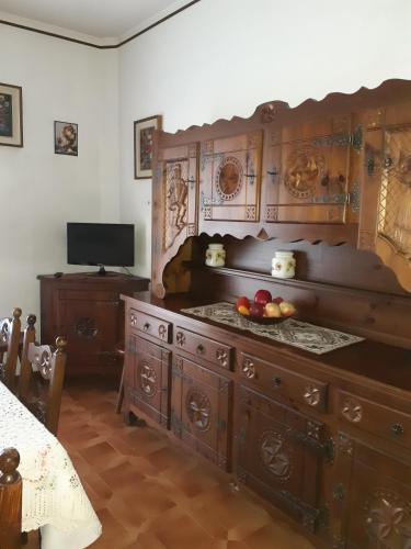 a kitchen with a large wooden cabinet with fruit on it at ALLOGGIO ARCOBALENO in Brossasco