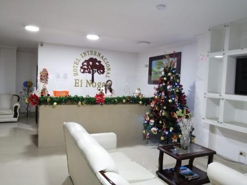 a living room with a christmas tree in a room at INTERNACIONAL EL NOGAL in Ipiales