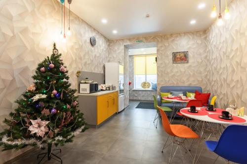 a living room with a christmas tree in a kitchen at Отель Баларам in Tula