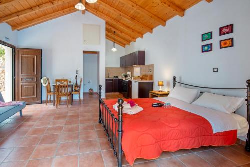 a bedroom with a large red bed in a room at Bask in the Beauty of Paxoi - Kirki's Summer Retreats with Private Jacuzzis in Ieromónachos
