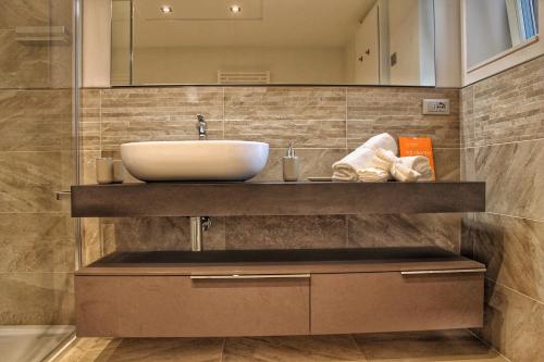 a bathroom with a sink and a mirror at Bonapace Dolomites Apartments in Madonna di Campiglio