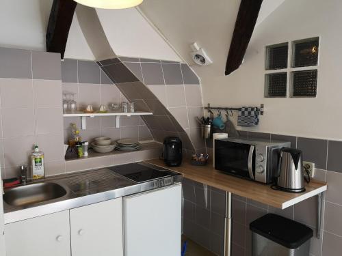 a small kitchen with a sink and a microwave at L1 - Green and cosy flat close Paris - WIFI in Longjumeau