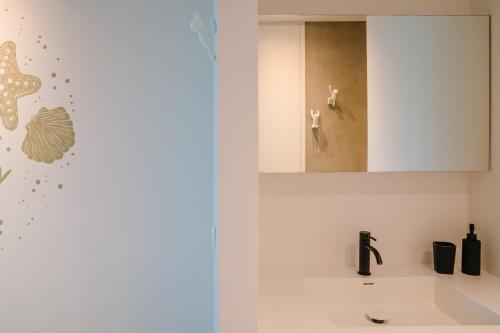 a bathroom with a sink and a mirror at Studio47 in Ostend