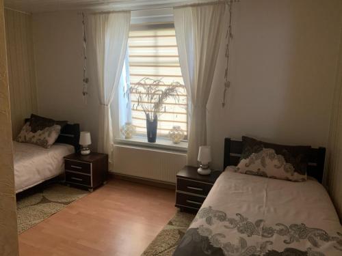 a bedroom with two beds and a window at Agro na Wapniarni in Białla