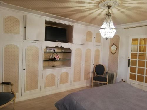 a bedroom with a bed and a tv on a wall at Fouettara in Firminy