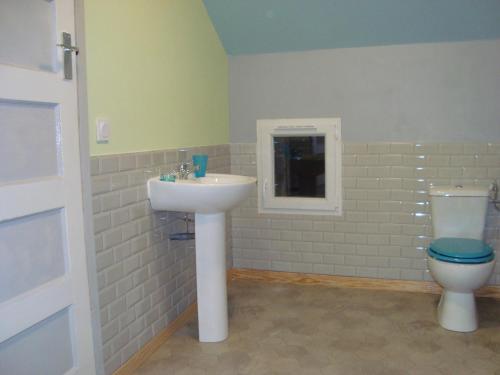 a bathroom with a sink and a toilet at 53Bou in Uglas