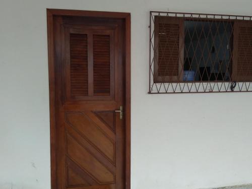 a wooden door and a window on a building at Ótima Suíte - Ponta Negra in Natal