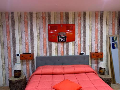 a bedroom with a red bed with a red cover at Eco Home in Bracciano