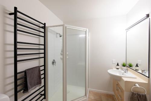 a bathroom with a shower and a sink at Ocean Retreat 228 in Mount Maunganui