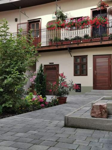 a building with flowers and plants in front of it at 5Churches Apartment in Győr