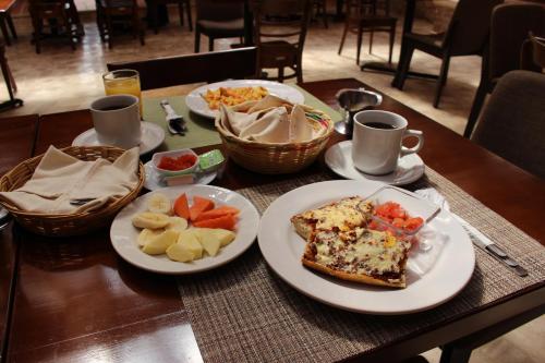 a table with plates of food on top at Parador Margarita in San Cristóbal de Las Casas