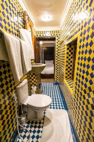 a bathroom with a toilet and a sink at Riad Fes Aicha & SPA in Fès