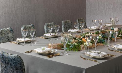 a table with wine glasses and plates on it at Hotel Madera in Washington