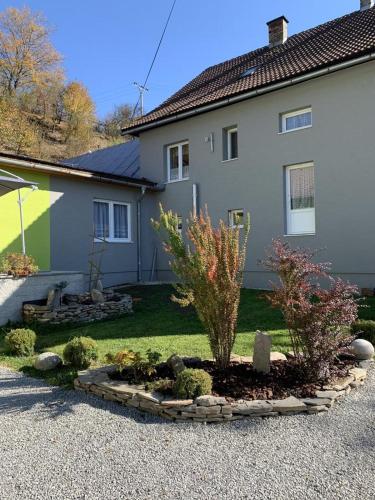 a house with a garden in front of it at Ubytovanie pod Skalkou in Dolný Kubín