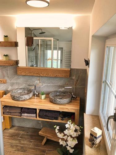 two sinks in a bathroom with a mirror at Ferienhaus Bergvagabund in Schönau am Königssee