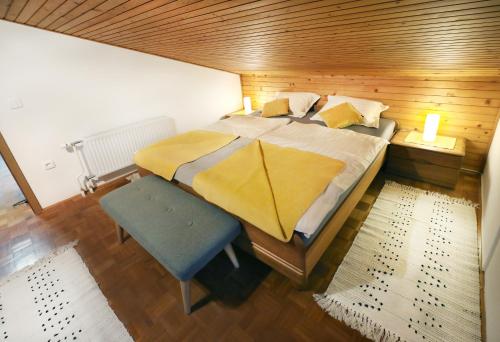 a bedroom with a large bed and a wooden ceiling at Apartma Vila Zigmund in Cerknica