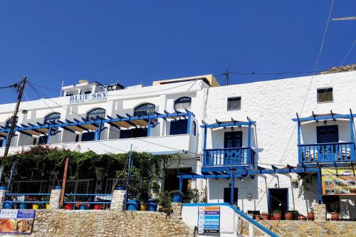 a white building with blue balconies on the side of it at Blue Sky Aparts in Livadia