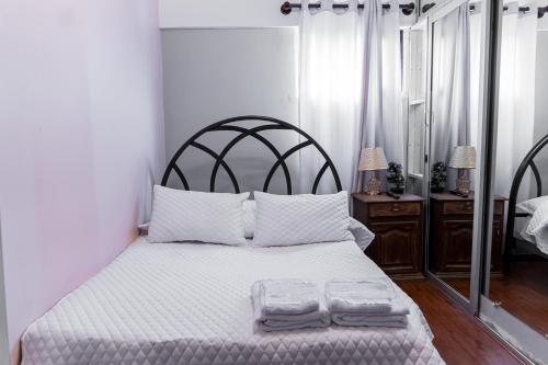 a bedroom with a bed with two towels on it at Residencial Velia & Victoria in Cochabamba