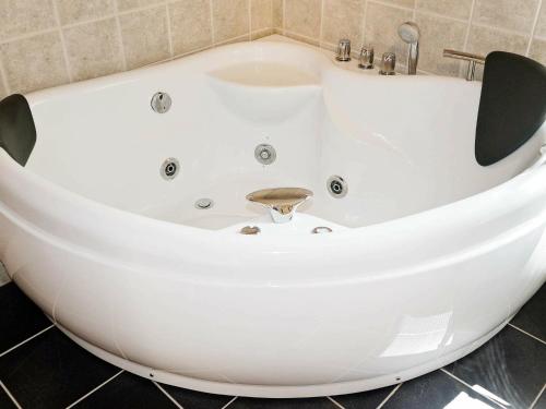 a white bath tub in a bathroom at 4 person holiday home in TYRINGE in Tyringe