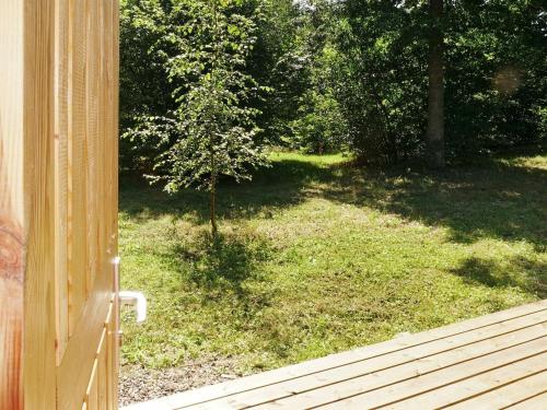 an open door to a yard with a tree at 4 person holiday home in TYRINGE in Tyringe