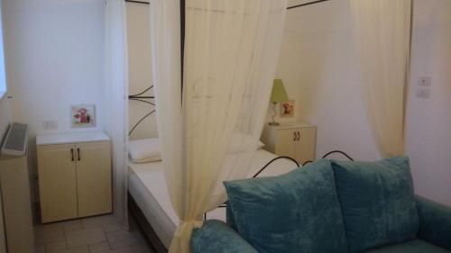 a room with a couch and a bedroom with a bed at Morrovalle LOVE in Morrovalle
