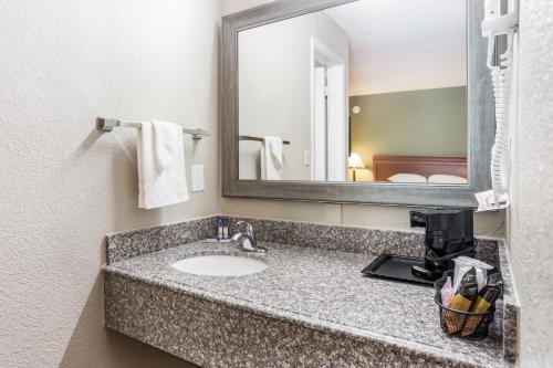 La salle de bains est pourvue d'un lavabo et d'un miroir. dans l'établissement Americas Best Value Inn - Lebanon, à Lebanon
