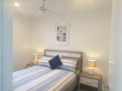 a bedroom with a bed with two night stands at Luxury Beach Front Appartment in Rosebud