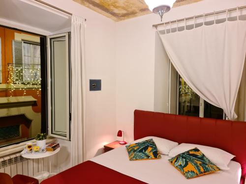 a bed with two pillows in a room with a window at I Dormienti in Rome