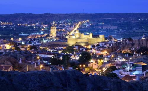 a view of a city at night at Hotel Mari Carmen in Guadix