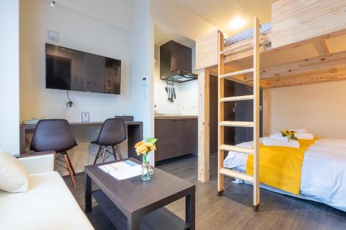 a bedroom with a bunk bed and a living room at VACATION INN KAMATA I in Tokyo