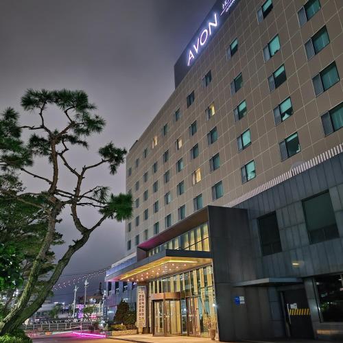 a hotel building with a sign on top of it at Avonhotel Gunsan in Gunsan