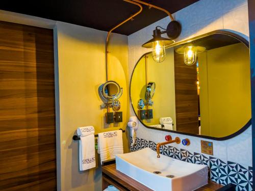 a bathroom with a sink and a mirror at Cadillac Hotel Boutique in Mexico City