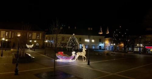 a christmas display in a parking lot at night at Forst-Ház Apartman in Eger